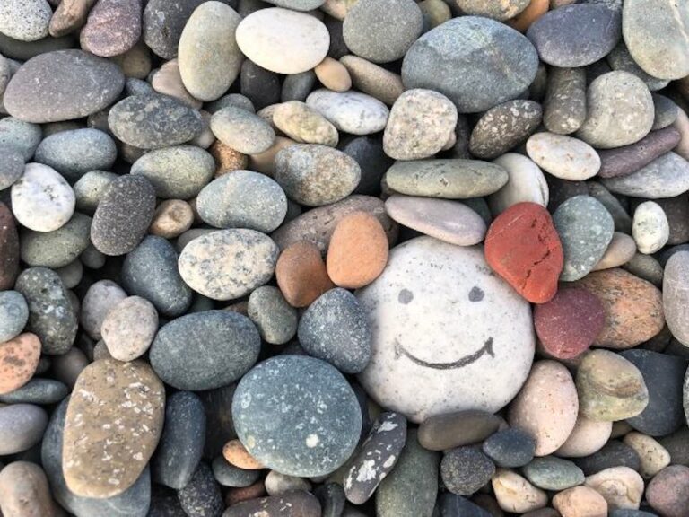 An image of rocks with a smiley face drawn on