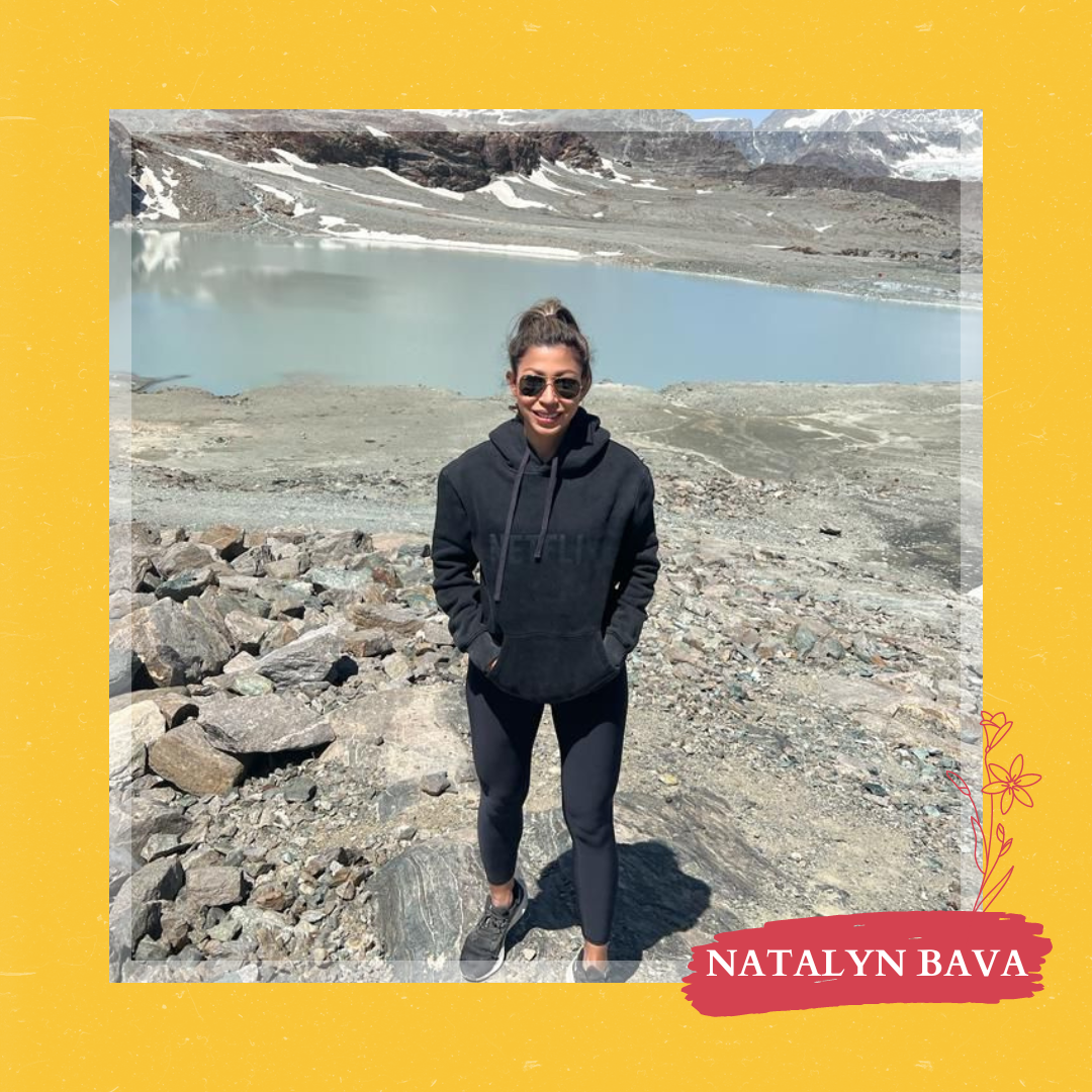 Lady in Netflix hoodie posing in front of an icy mountain terrain